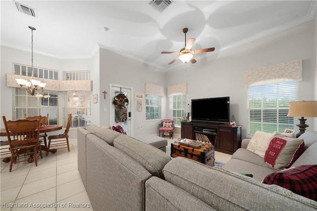 tiled living room featuring a towering ceiling, ceiling fan with notable chandelier, and ornamental molding