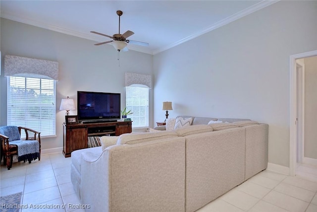 living area with ceiling fan, ornamental molding, baseboards, and light tile patterned flooring