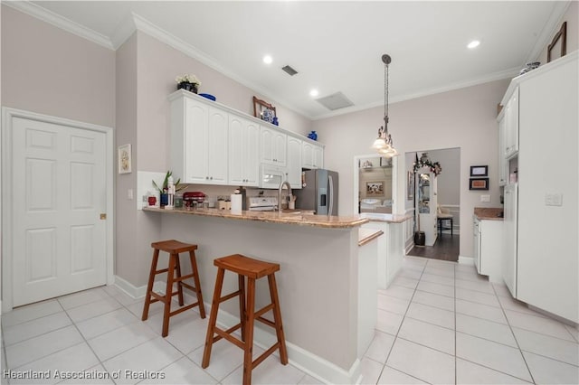 kitchen with white cabinets, stainless steel refrigerator with ice dispenser, ornamental molding, decorative light fixtures, and kitchen peninsula