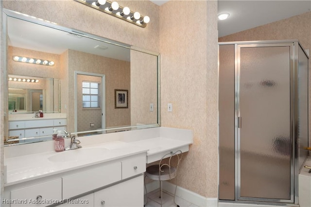 bathroom featuring vanity, a shower with shower door, and vaulted ceiling