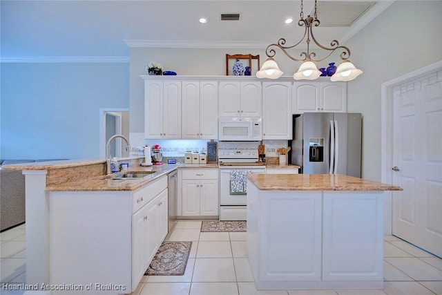 kitchen featuring pendant lighting, visible vents, appliances with stainless steel finishes, a sink, and light stone countertops