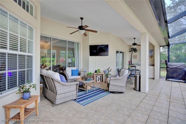 view of patio with a lanai, an outdoor living space, and a ceiling fan