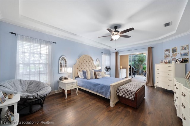 bedroom featuring ceiling fan, dark hardwood / wood-style flooring, access to outside, and a tray ceiling