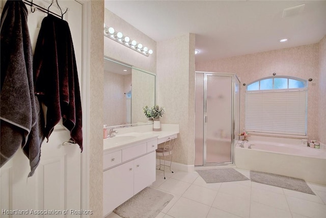 full bathroom with a stall shower, a garden tub, vanity, and tile patterned floors