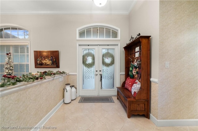 entryway featuring ornamental molding and french doors