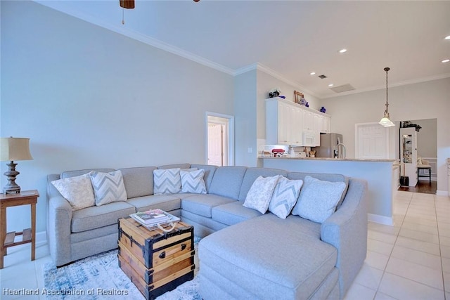 living area with crown molding, light tile patterned floors, recessed lighting, a ceiling fan, and baseboards