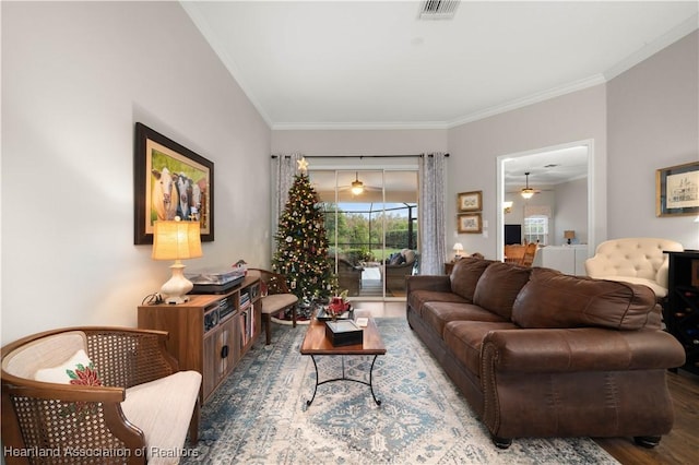 living room with wood-type flooring and crown molding