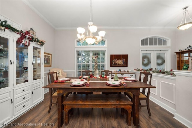 dining room with dark hardwood / wood-style flooring, an inviting chandelier, and crown molding