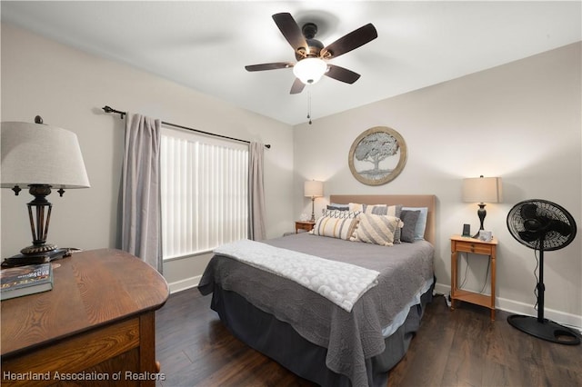 bedroom with ceiling fan and dark hardwood / wood-style flooring