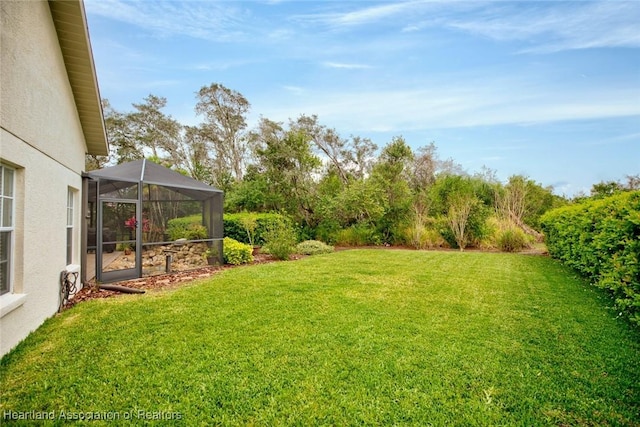 view of yard featuring glass enclosure