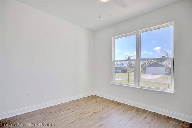 unfurnished room with ceiling fan and light wood-type flooring