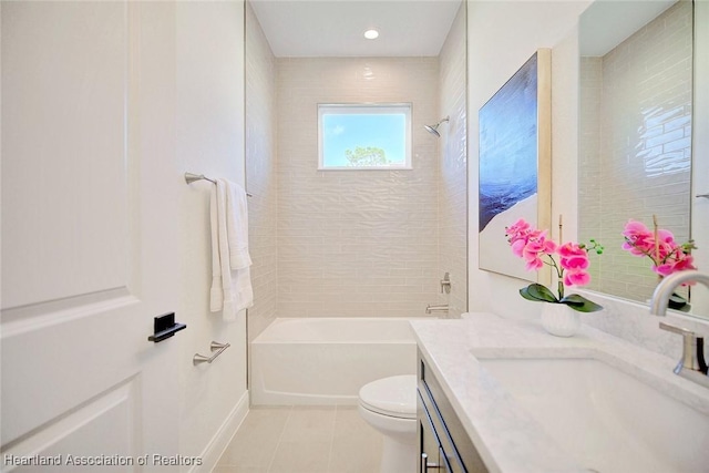 full bathroom with tile patterned floors, toilet, tiled shower / bath, and vanity