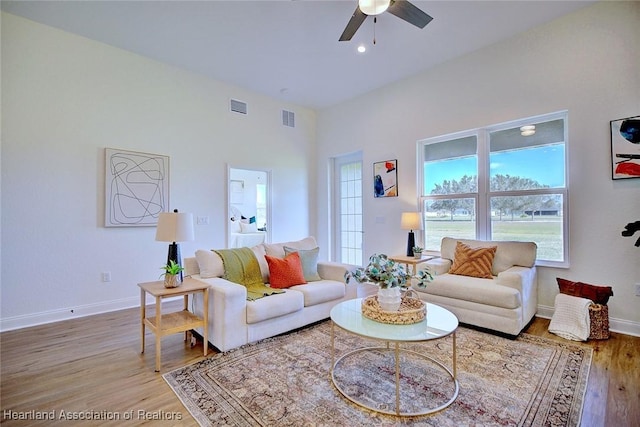 living room with ceiling fan and hardwood / wood-style floors