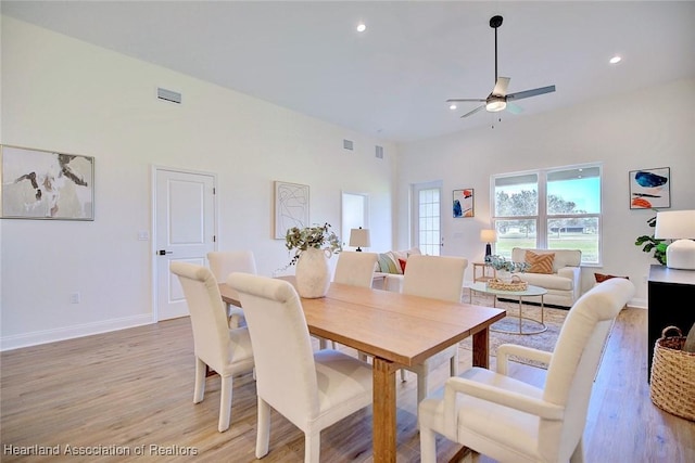 dining area with ceiling fan and light hardwood / wood-style floors