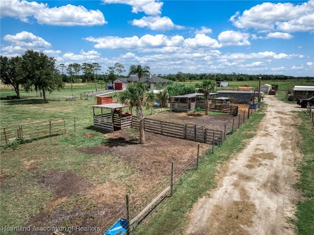 surrounding community with a rural view, an outdoor structure, and an exterior structure