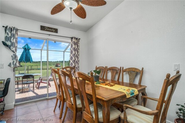 dining area with lofted ceiling, a ceiling fan, and tile patterned floors