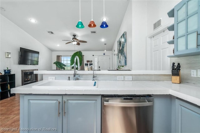 kitchen with light countertops, a sink, visible vents, and stainless steel dishwasher