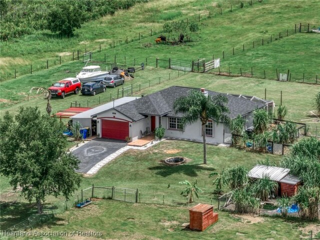 ranch-style house with a front yard and a garage