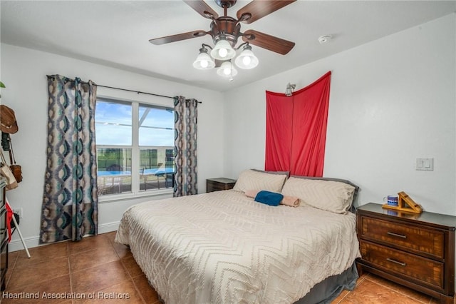 tiled bedroom with a ceiling fan and baseboards