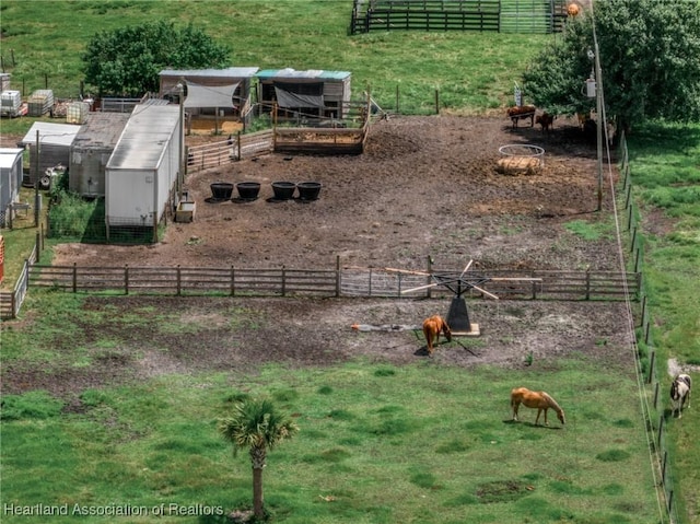 view of yard featuring a rural view and an outdoor structure