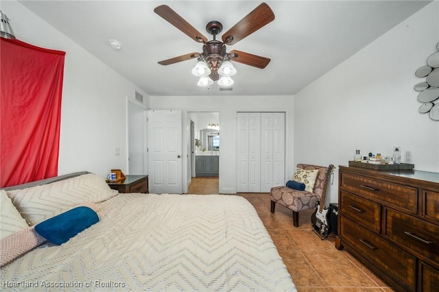 bedroom featuring a closet, visible vents, a ceiling fan, light tile patterned flooring, and connected bathroom