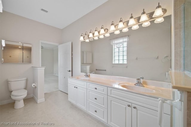 bathroom with tile patterned floors, vanity, and toilet