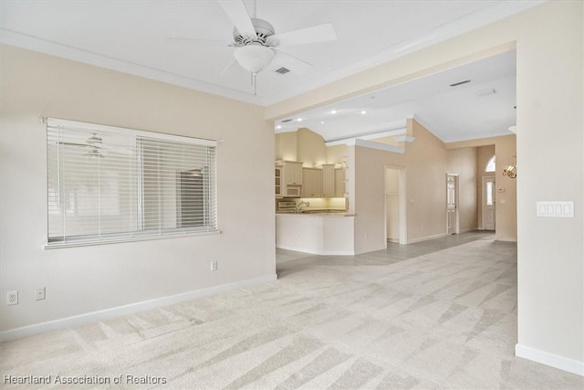 unfurnished room featuring light carpet, ornamental molding, ceiling fan, and lofted ceiling