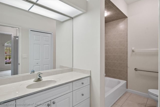 full bathroom with tile patterned floors, vanity, toilet, and tiled shower / bath combo