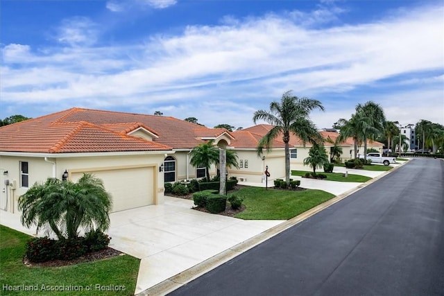 mediterranean / spanish-style house with a garage and a front yard