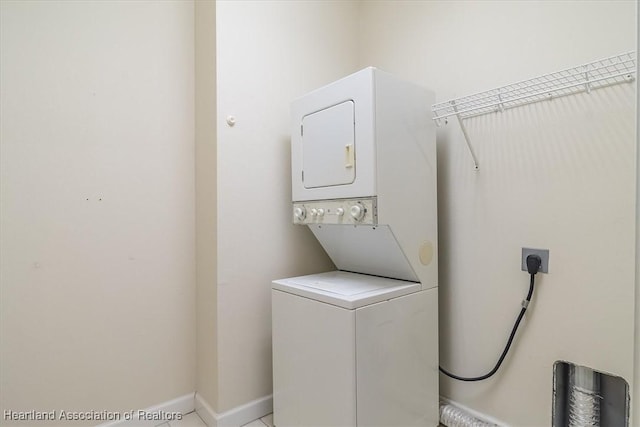 laundry room with stacked washing maching and dryer