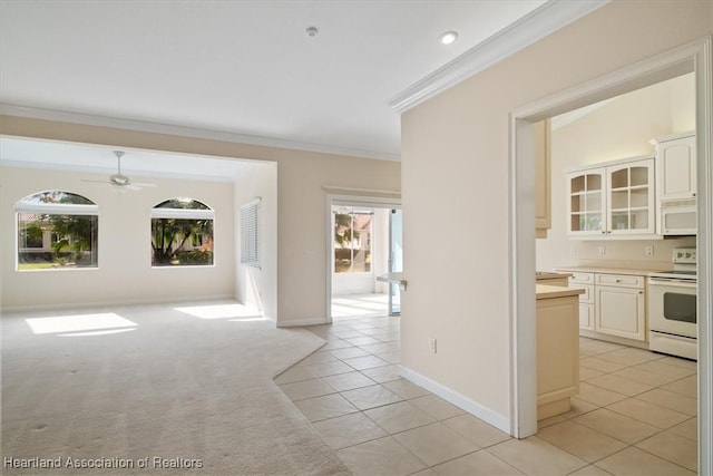 interior space with ceiling fan, light tile patterned floors, and ornamental molding