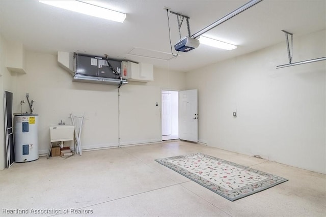 garage with electric water heater, sink, and a garage door opener