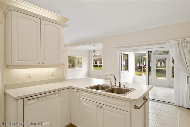 kitchen with dishwasher, sink, light tile patterned floors, ornamental molding, and kitchen peninsula