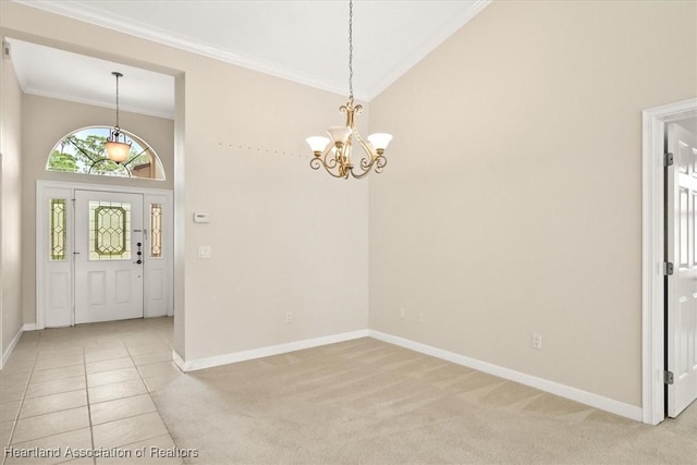 tiled entryway with high vaulted ceiling, a chandelier, and ornamental molding