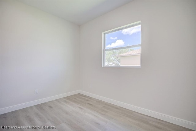 spare room featuring light wood-type flooring