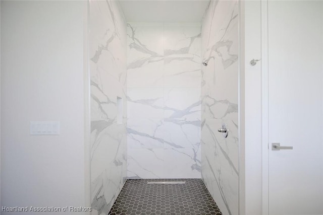 bathroom with a tile shower