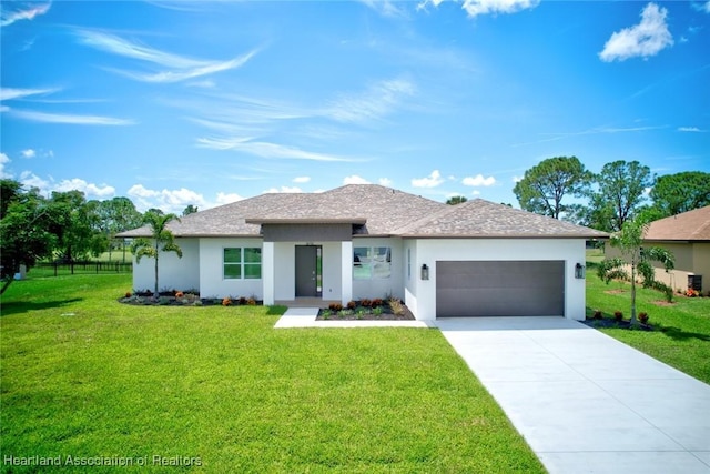 view of front of home with a front yard and a garage