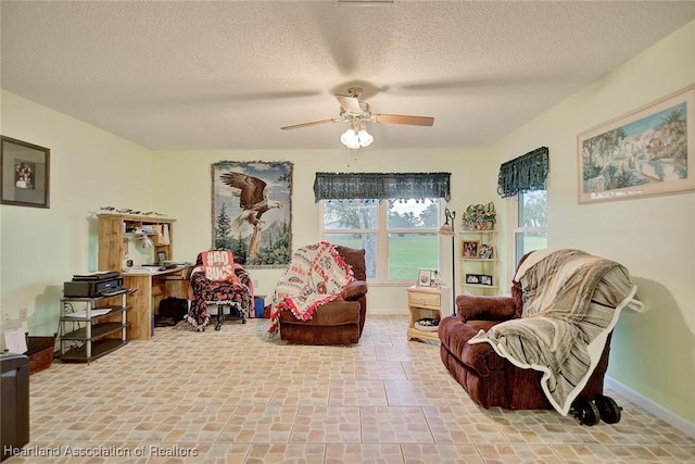 sitting room featuring a textured ceiling and ceiling fan