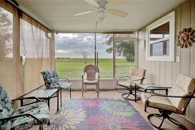 sunroom / solarium featuring ceiling fan