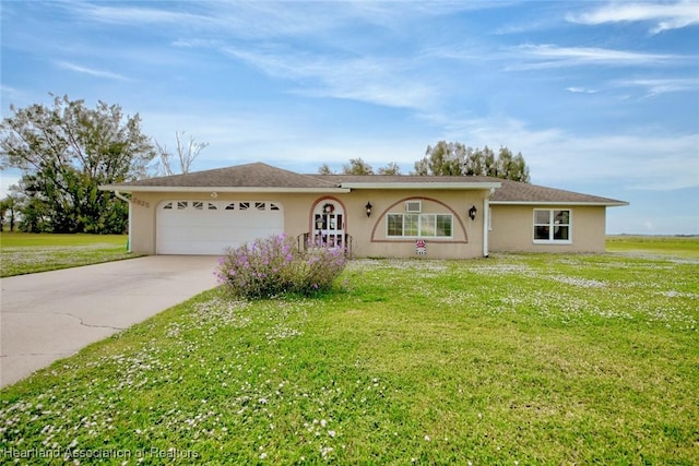 ranch-style house featuring a front yard and a garage