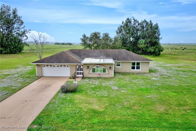 ranch-style house with a rural view, a front yard, and a garage