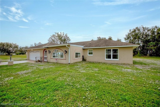 view of front of house featuring a garage and a front lawn