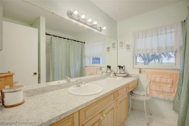 bathroom with vanity and a textured ceiling