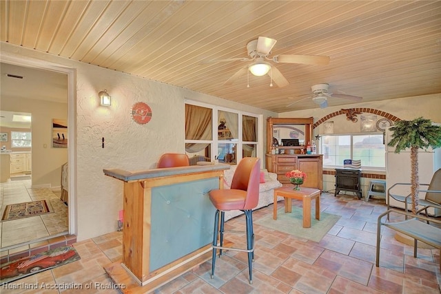 interior space with ceiling fan and wooden ceiling