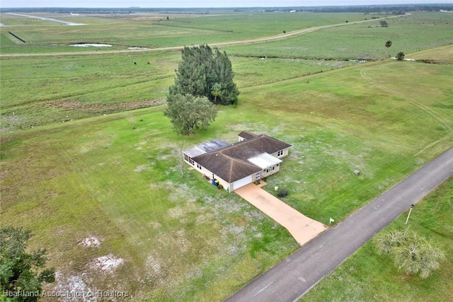 birds eye view of property with a rural view