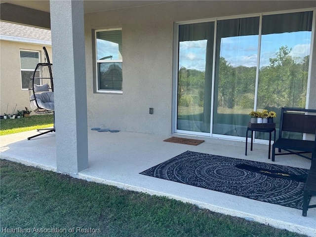 entrance to property featuring a patio area