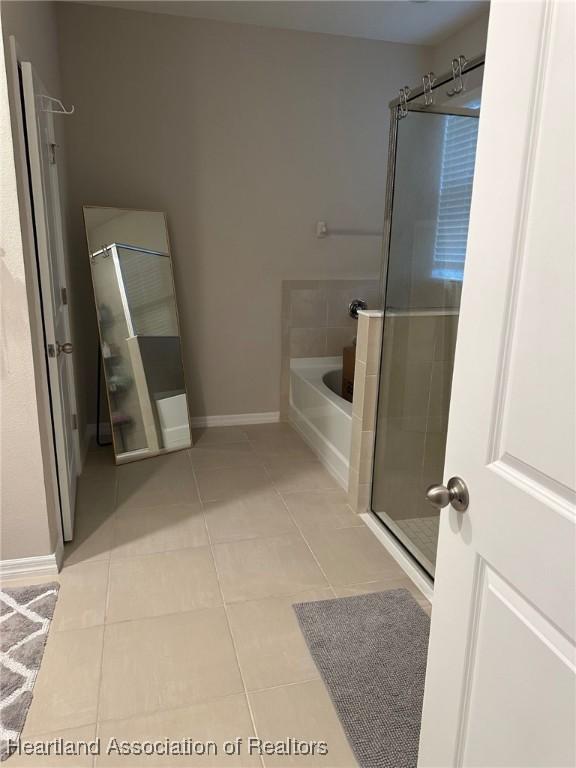 bathroom with plus walk in shower and tile patterned floors