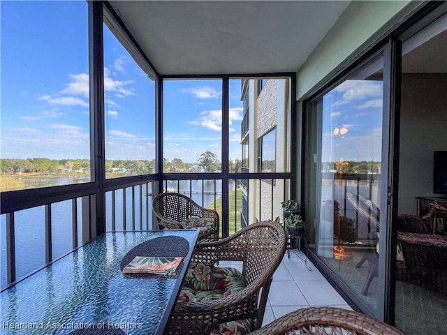 sunroom / solarium with a water view and a wealth of natural light