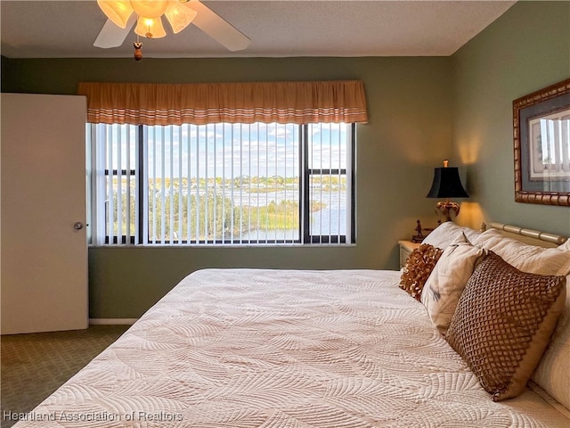 bedroom with ceiling fan and carpet floors