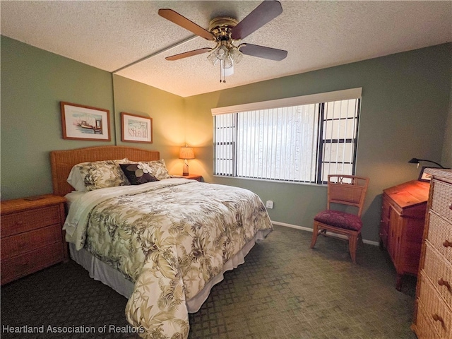 bedroom with ceiling fan and a textured ceiling